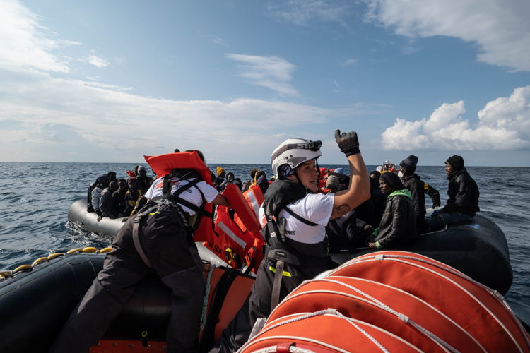 MSF search and rescue team members, Carolina and Fulvia are handing out life jackets to survivors on a boat during a rescue operation on 7 January 2023. Photographer Nyancho NwaNri. Date: 07/01/2023. Location: Mediterranean Sea MSF search and rescue team members, Carolina and Fulvia are handing out life jackets to survivors on a boat during a rescue operation on 7 January 2023. Photographer Nyancho NwaNri. Date: 07/01/2023. Location: Mediterranean Sea