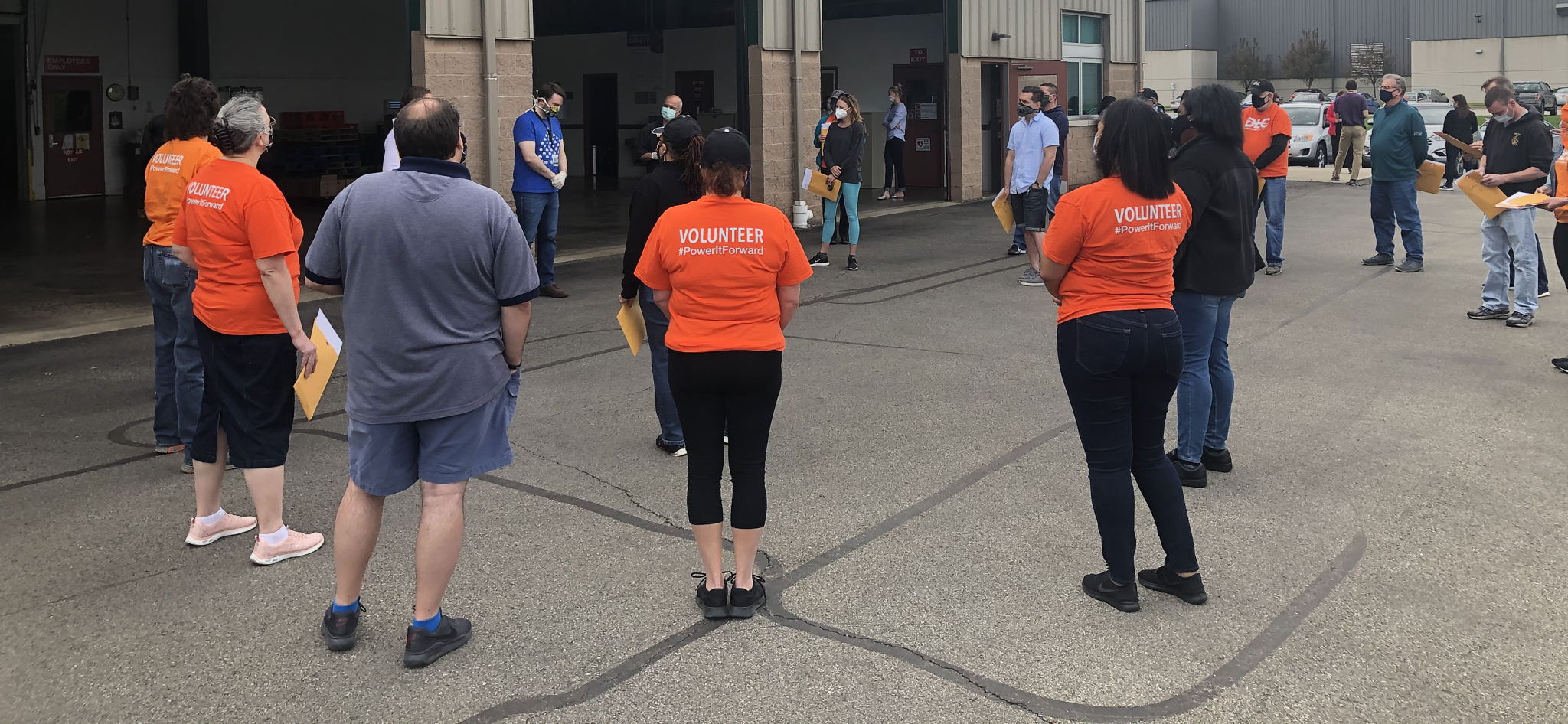 DLC employee volunteers are given instructions before delivering food.