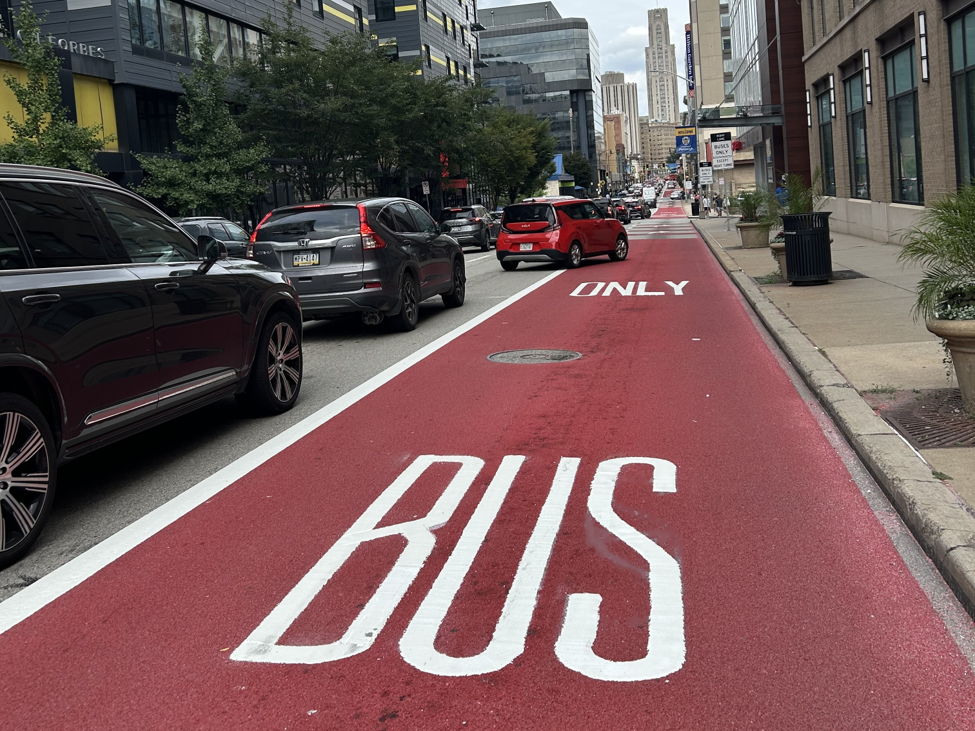 White lettering recently placed on the Forbes Avenue Bus Lane in Oakland