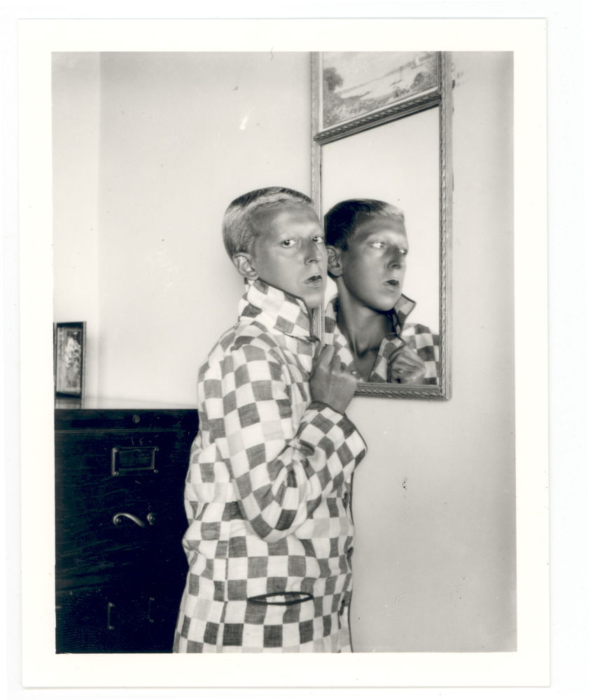 Self-portrait (reflected image in mirror, checqued jacket) by Claude Cahun, 1928. Jersey Heritage Collections © Jersey Heritage 