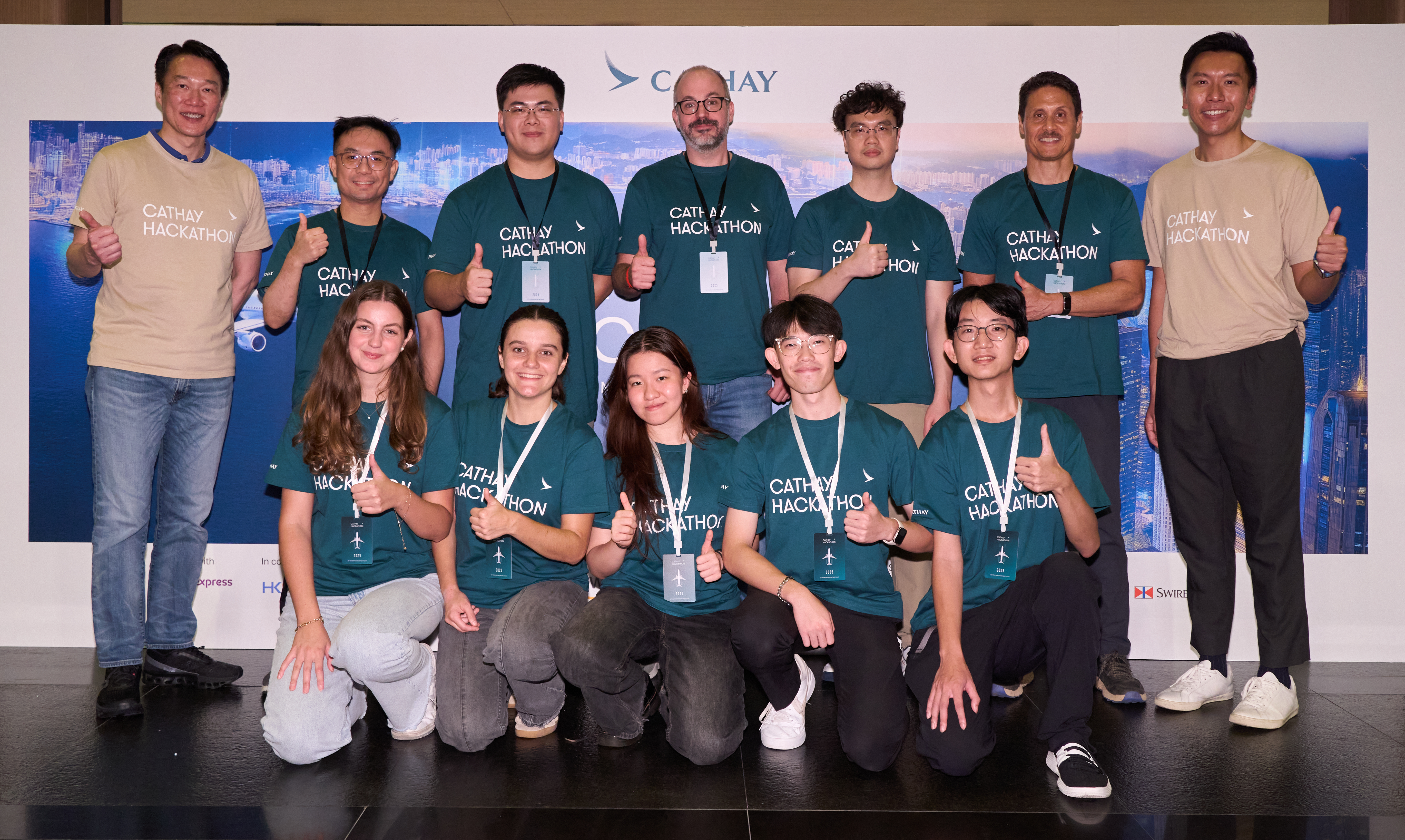 Cathay Director Digital and IT Lawrence Fong and General Manager Digital Aldric Chau congratulate the Student Track Champion Team Kairos Takeoff Crew and Employee Track Champion Team FlyLab