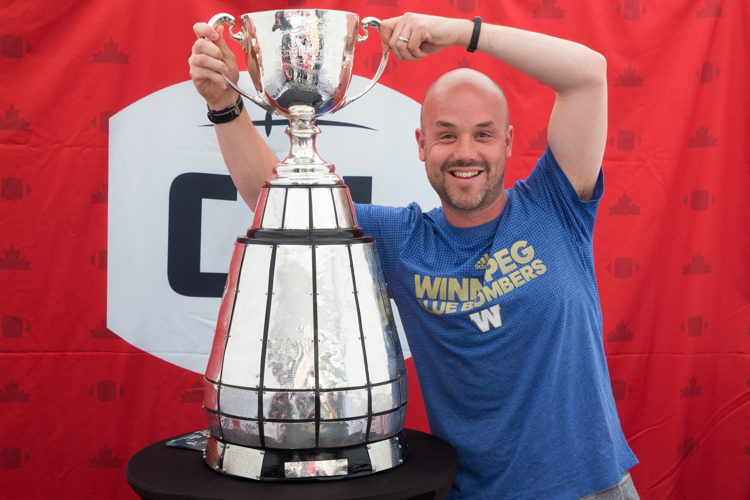 Winnipeg Blue Bombers fan poses with the Grey Cup. Photo Credit: Jim Ross/CFL