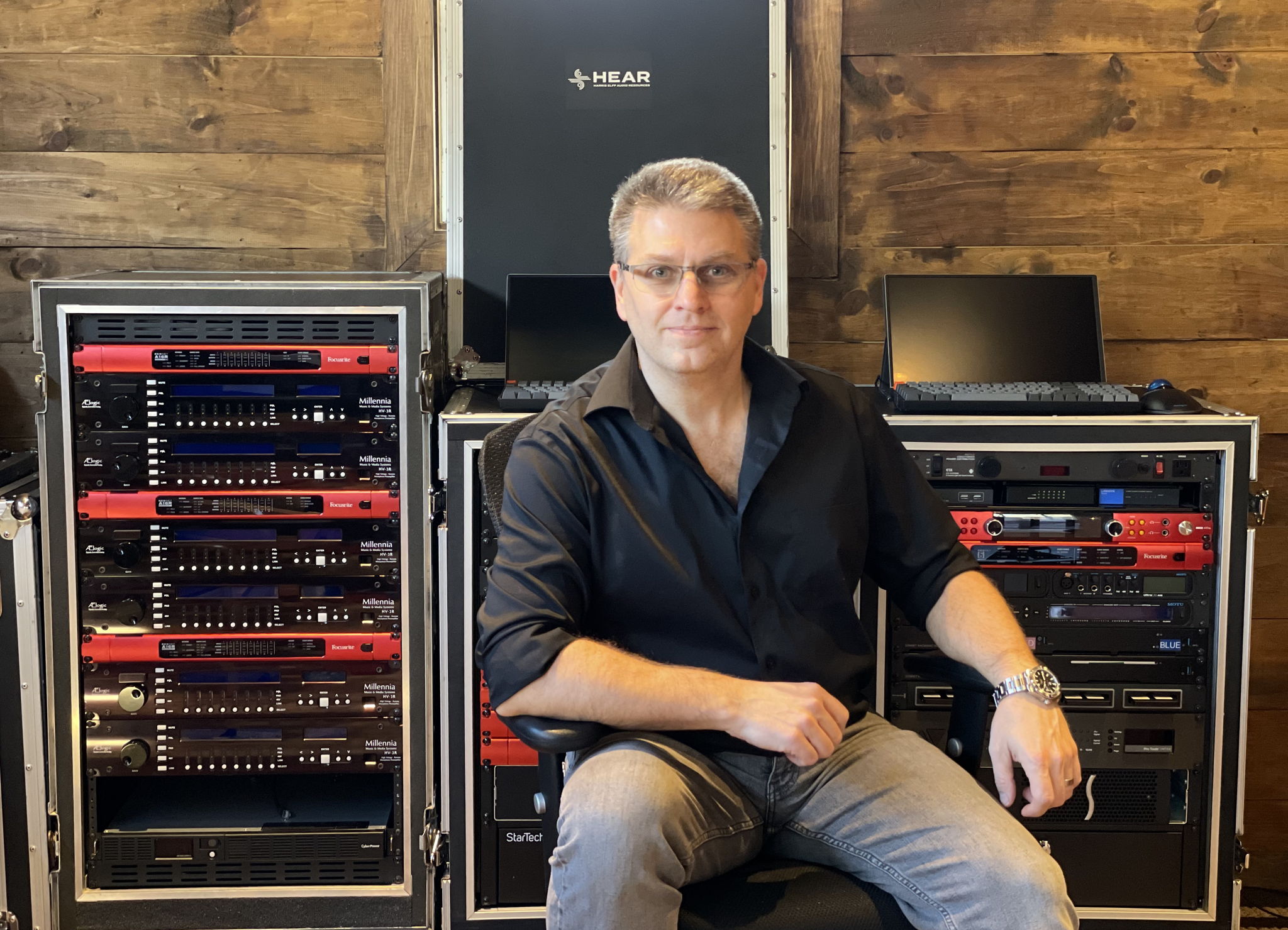 Jody Elff with two of HEAR's compact remote mixing racks. These racks save space on-site while providing an uninterruptible audio signal flow to broadcast.