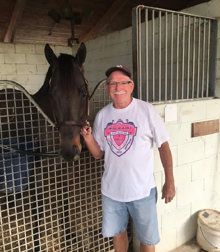 Nicholas Gonzalez poses with his stable standout, Silent Poet, in the Woodbine backstretch. (Supplied)