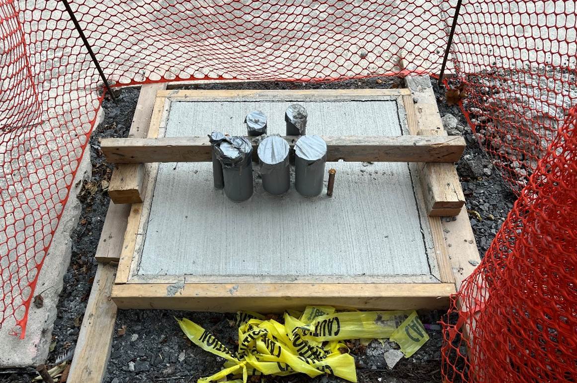 Recently poured concrete foundation to support new traffic controller box