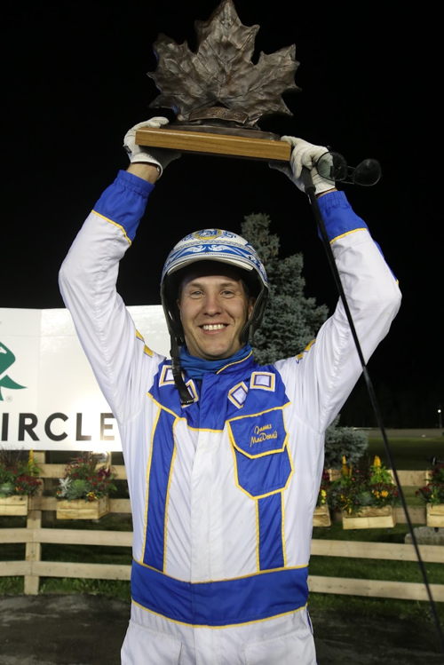 James MacDonald with the Maple Leaf Trot trophy after Lindy The Great's win in September 2021. (New Image Media)