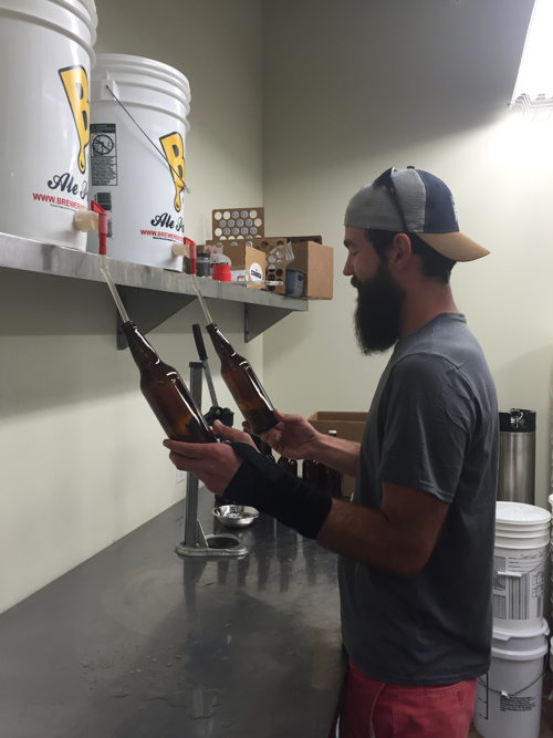 William Brant of CO-Brew fills sanitized bottles with the cantaloupe gose