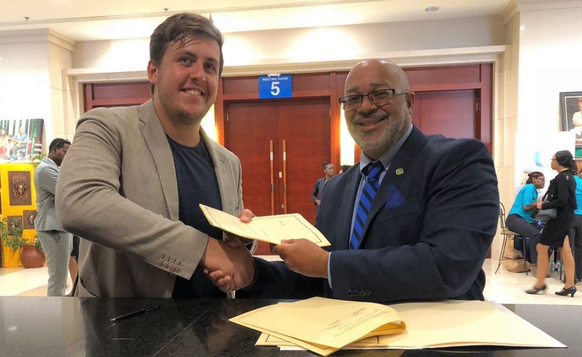Dr. Didacus Jules, Director General of the OECS Commission and Mr. James Ellsmoor, Director of SHOS sign Memorandum of Understanding.