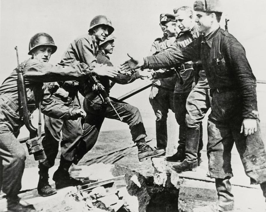 "Handshake of Torgau." Red Army and US soldiers shake hands on the destroyed bridge at Torgau. AKG84220 © akg-images