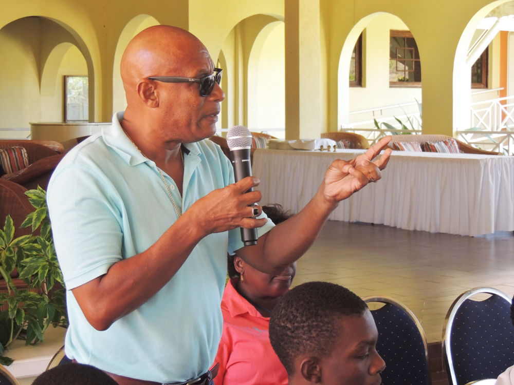 Audience member addresses the panel at the Vini Koze Forum on Economic Growth in Grenada.