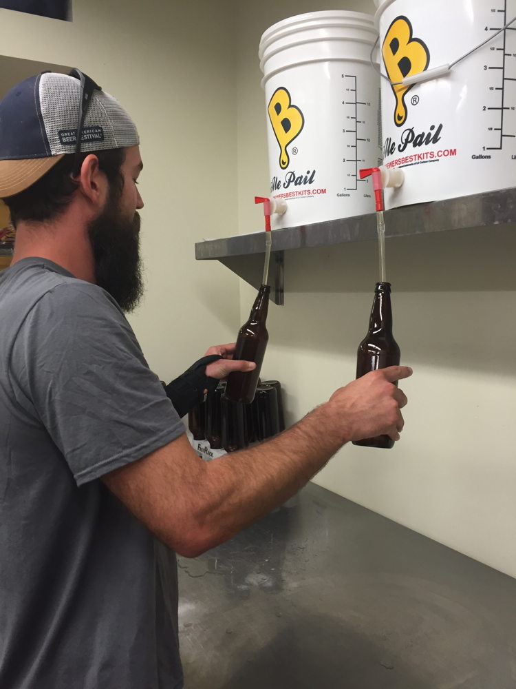 William Brant fills sanitized bottles with Worth the Wait Cantaloupe Gose