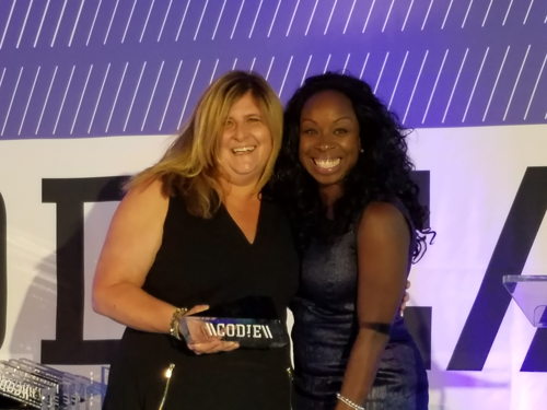x2VOL CEO, Michele Pitman, accepts a 2017 CODiE Award for exceptional education technology from Nicole Neal, CEO of Noodle Markets.