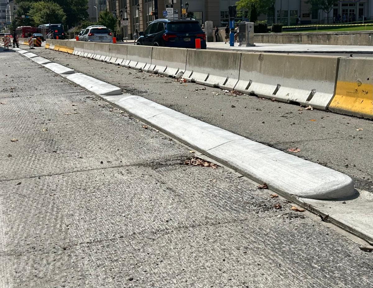 Concrete buffers separating the future bi-directional bike lane from vehicles on Fifth Avenue