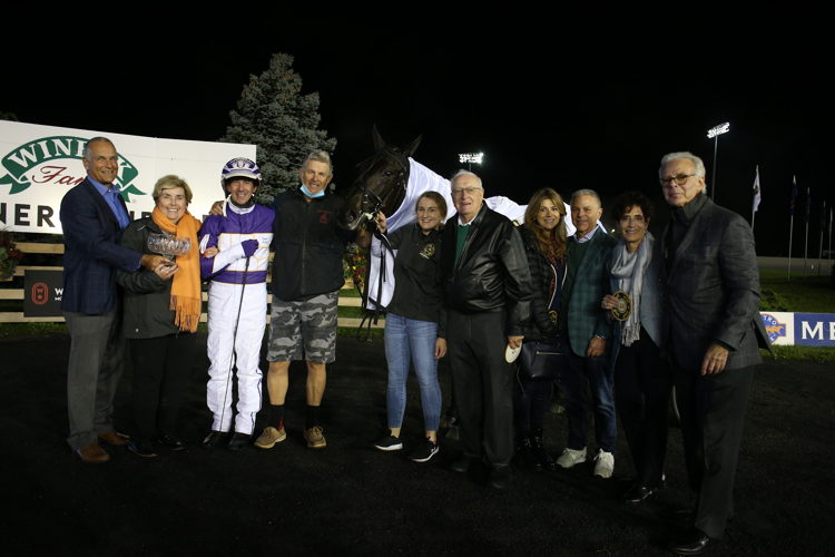 The connections of Venerable are presented with the Mohawk Million trophy by Jim Lawson, CEO of Woodbine Entertainment. (New Image Media)