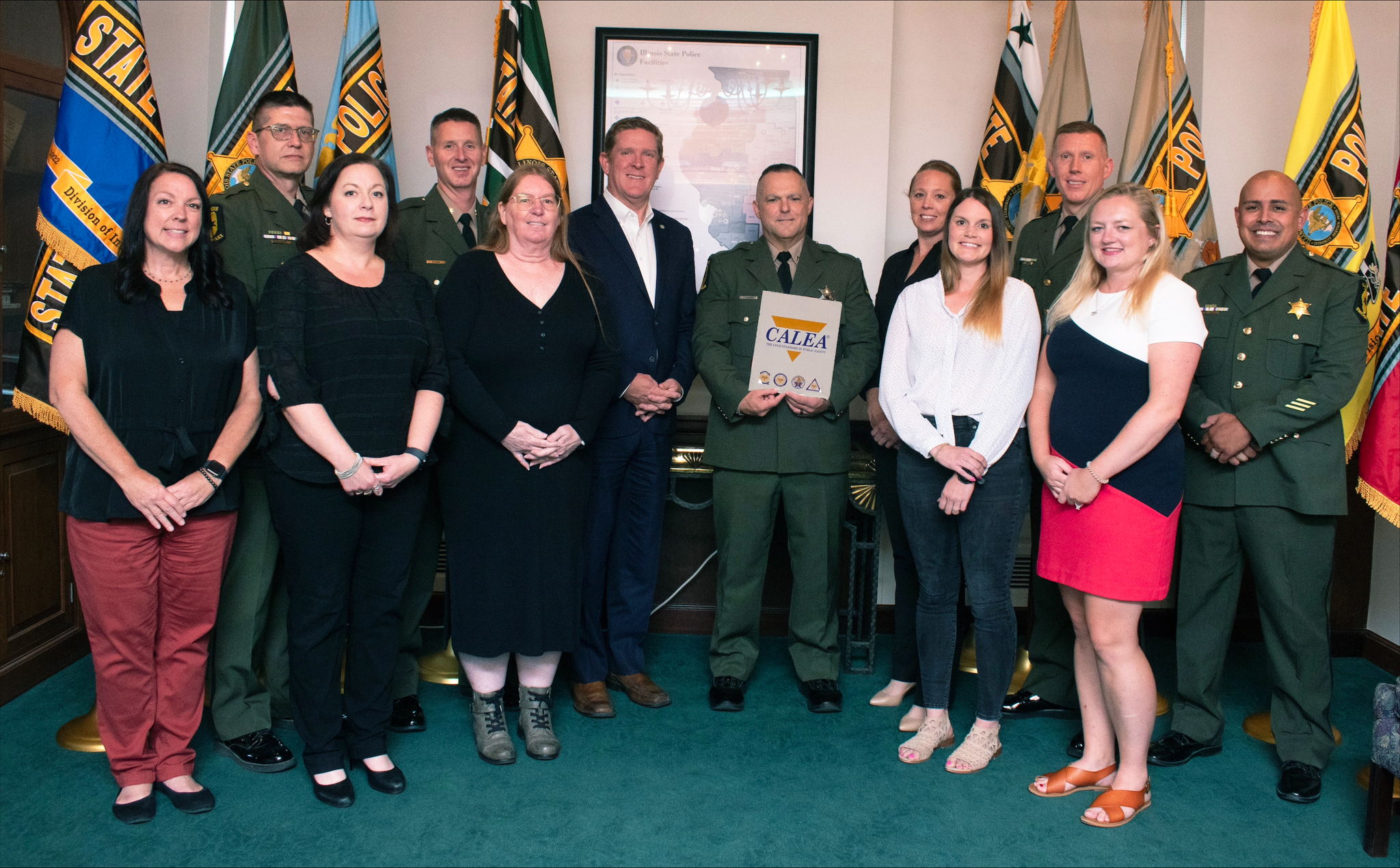 ISP CALEA Accreditation Team. Back row from left to right - Lt. Tim Good, Major Brandon Davis, Director Brendan F. Kelly, Trooper Brennan Summers, First Deputy Director Rebecca Hooks, Colonel Christopher Campbell, Acting Master Sergeant Robert Matos. Front row from left to right - Maretta Sullivan, Megan Moore, Margaret Adams, Keri Casson, Katie Clements. ISP CALEA Accreditation Team. Back row from left to right - Lt. Tim Good, Major Brandon Davis, Director Brendan F. Kelly, Trooper Brennan Summers, First Deputy Director Rebecca Hooks, Colonel Christopher Campbell, Acting Master Sergeant Robert Matos. Front row from left to right - Maretta Sullivan, Megan Moore, Margaret Adams, Keri Casson, Katie Clements.