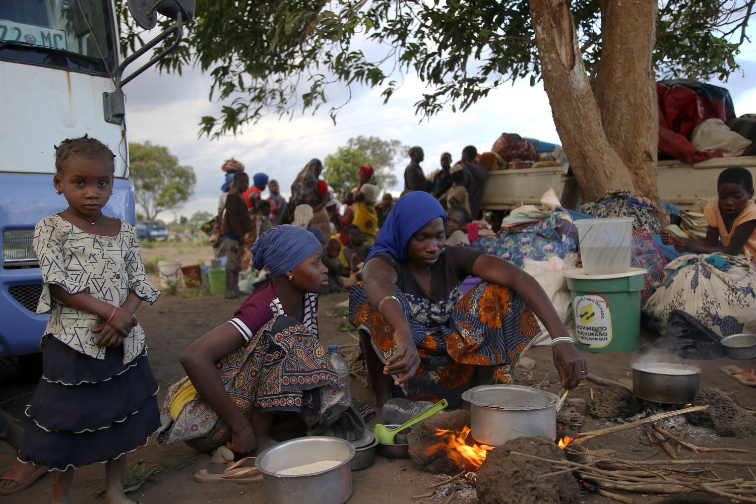 A woman cooks over an open fire, on the outskirts of Mueda, in the northern Mozambican province of Cabo Delgado.