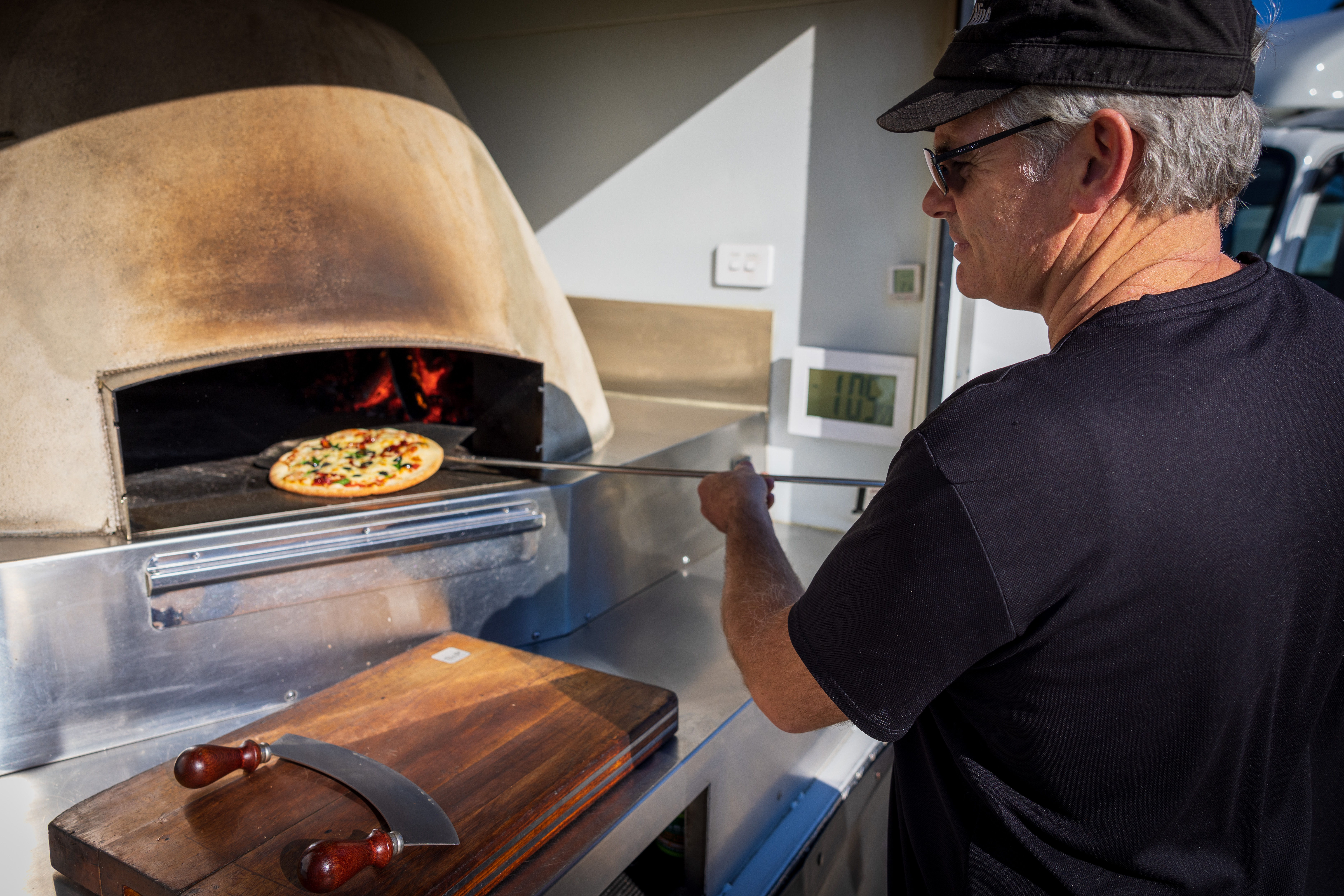 The set-up includes woodfired pizza ovens in both trucks