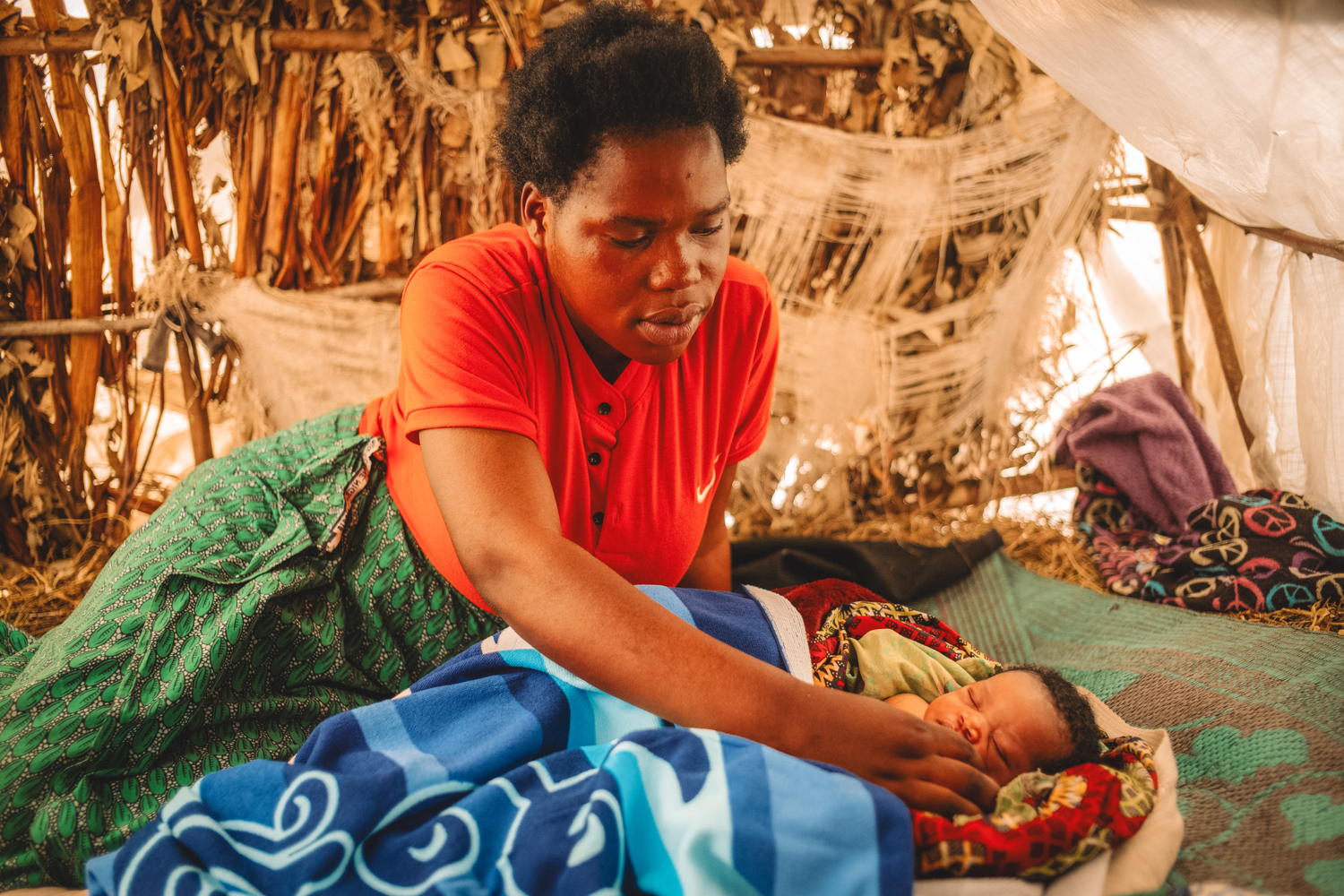 Copyright: Philémon Barbier Countries: Democratic Republic of Congo Date taken / Date Recorded: 08 January, 2024 Caption / Description: Gisele Dorika, 18, from Rugari in Rutshuru territory, looks after her daughter Justine in her tent on 8 January 2024 at the Bujari IDP site north of Goma, North Kivu, Democratic Republic of Congo. Her daughter was born three days earlier at the MSF-supported health centre in Kanyaruchinya