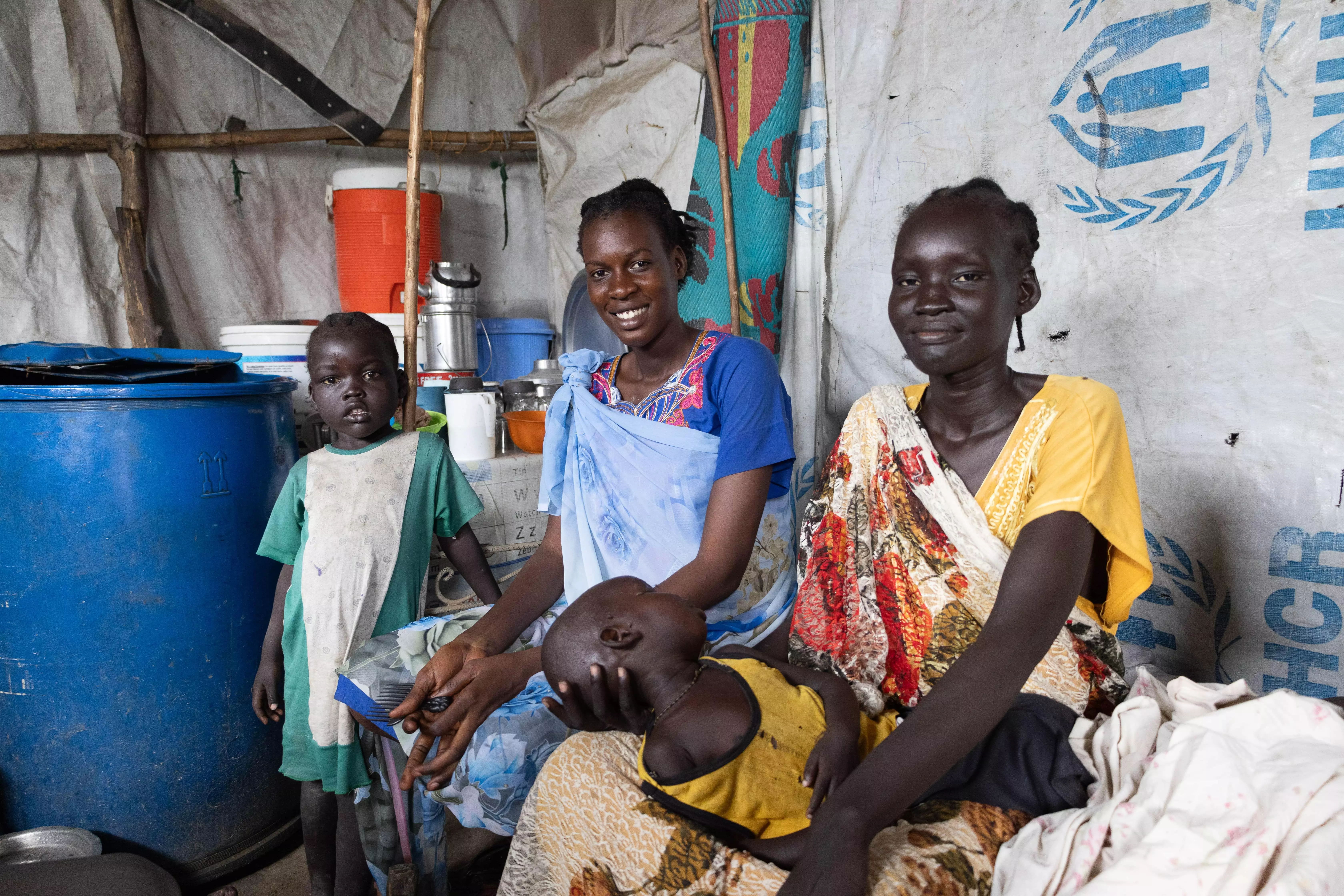 Nyachangjwok William Oguen arrived at the Protection of Civilians (PoC) site last April with her brother. Her child Zacharia Peter Dak (yellow shirt), four years old, is suffering from severe malnutrition. Photographer: Kristen Poels | Location: Malakal, Upper Nile State | Date: 23/05/2024