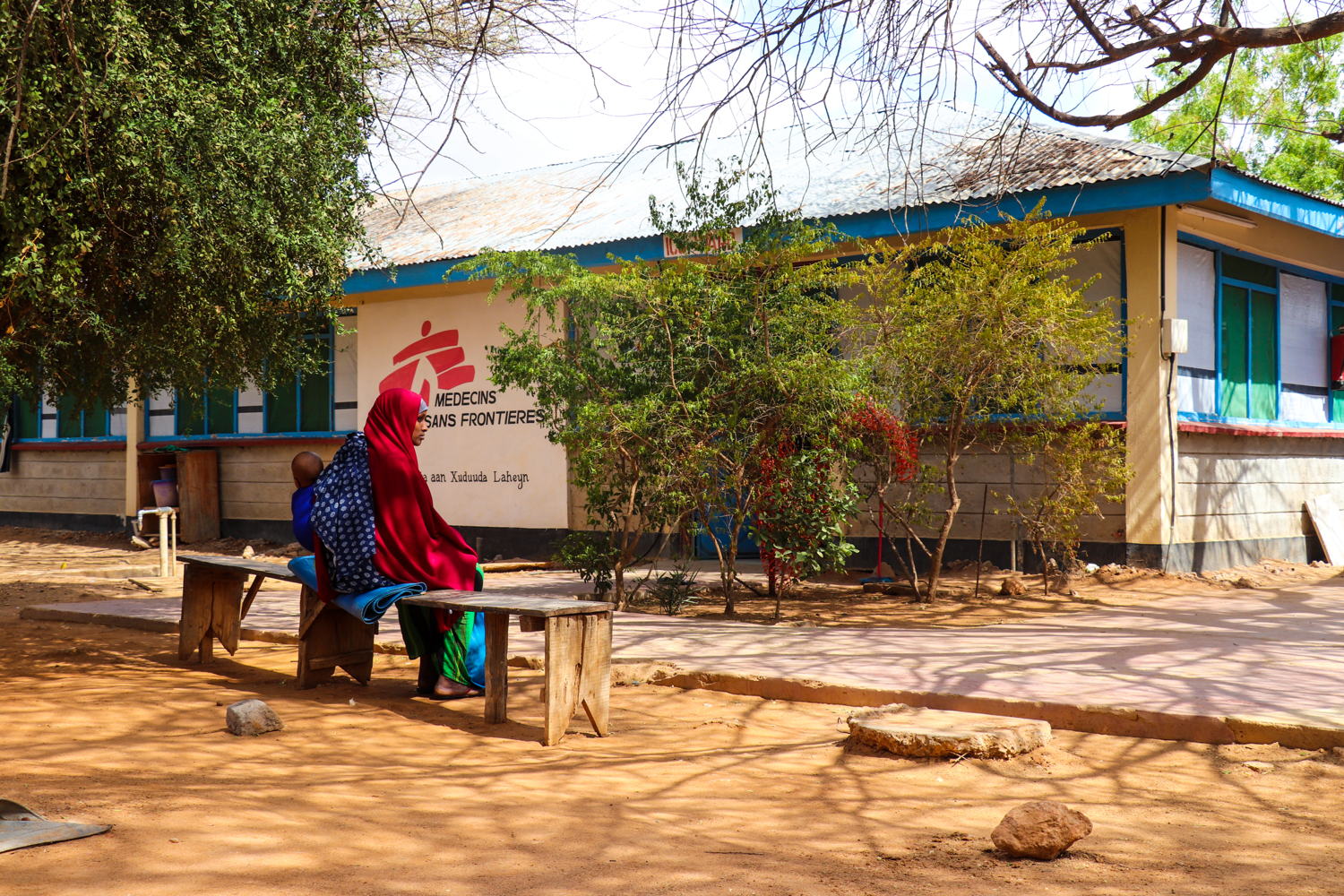 A patients waits outside an MSF consultation room to be seen by a medic