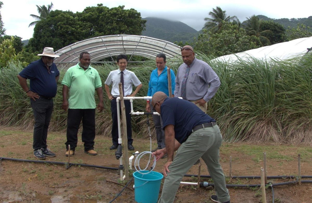 Minister of Agriculture in Saint Lucia, Hon. Ezechiel Joseph; Second Secretary Toshihide Kanaya, Embassy of Japan; and CARDI representative witness an Injector Irrigation Demonstration at the CARDI Field Station, Saint Lucia.