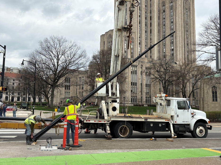 Crews installing decorative light poles on Forbes Avenue at Schenley Drive Crews installing decorative light poles on Forbes Avenue at Schenley Drive