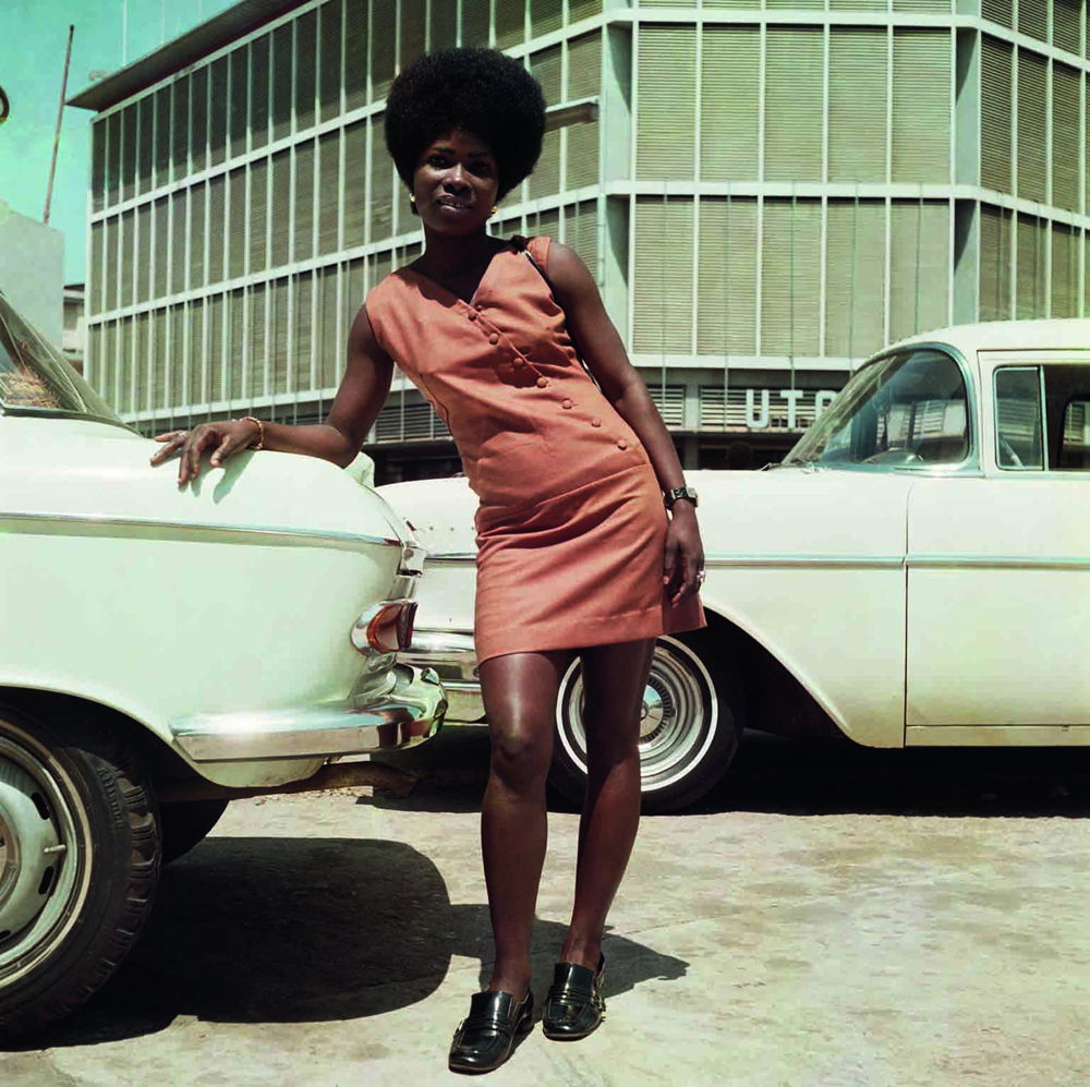 Sick Hagemeyer shop assistant as a seventies icon posing in front of the United Trading Company headquarters, Accra© James Barnor / Courtesy of Galerie Clémentine de la Féronnière