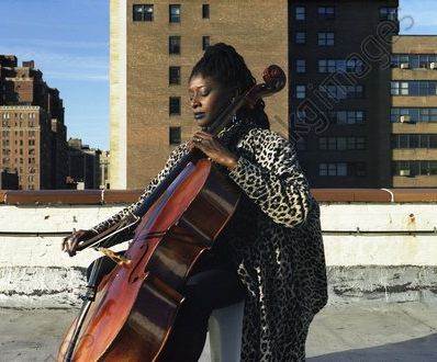 American Jazz cellist Akua Dixon playing on top of a roof in New York. AKG3543144